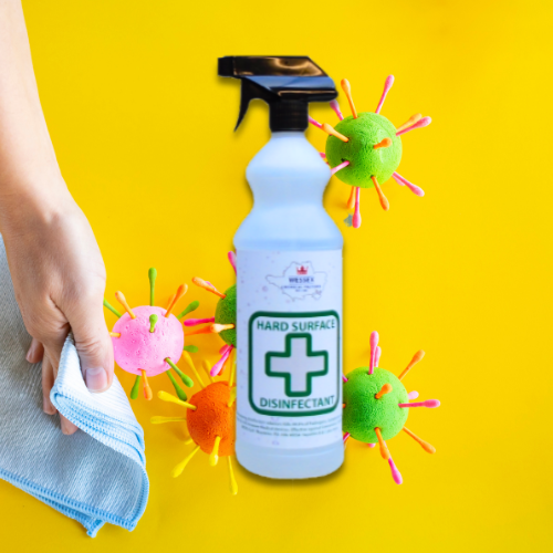 bottle of hard surface disinfectant in front of a picture of bacteria on a yellow background