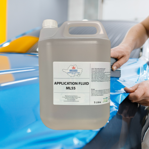 Bottle of application fluid in front of vinyl graphic application