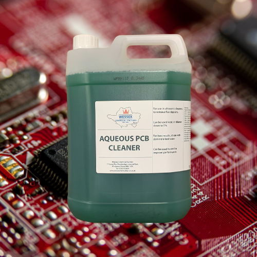 Bottle of Aqueous PCB Cleaner in front of a red circuit board
