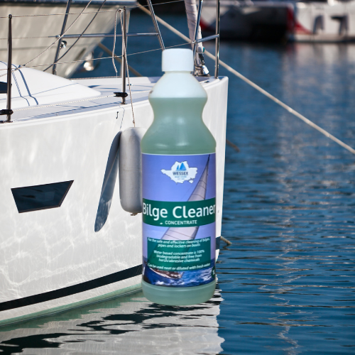 Bottle of 1 litre bilge cleaner in front of a boat on the water.