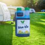 small bottle of blue bio in front of a caravan site