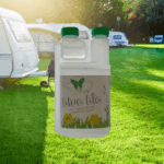 small bottle of blue bio in front of a caravan site
