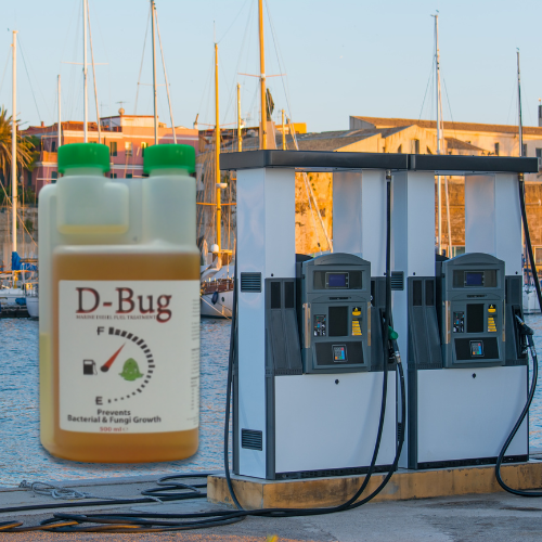 Bottle of D-Bug diesel additive in front of boat fuel pumps