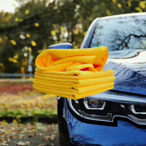 photo of microfibre cloths in front of a shiny car