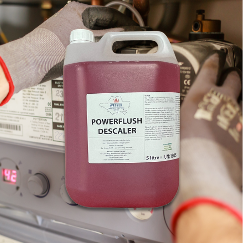 large bottle of powerflush descaler in front of a boiler