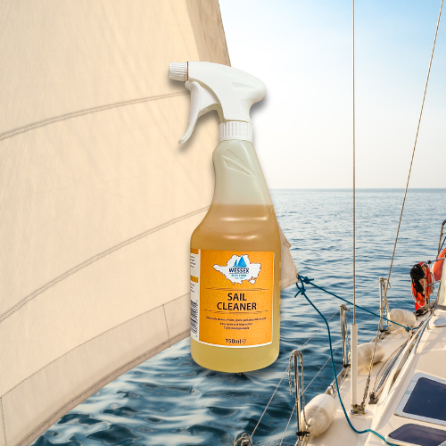 Bottle of sail cleaner in front of yacht sail