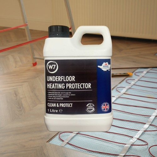 bottle of underfloor heating protector in front of underfloor heating installation