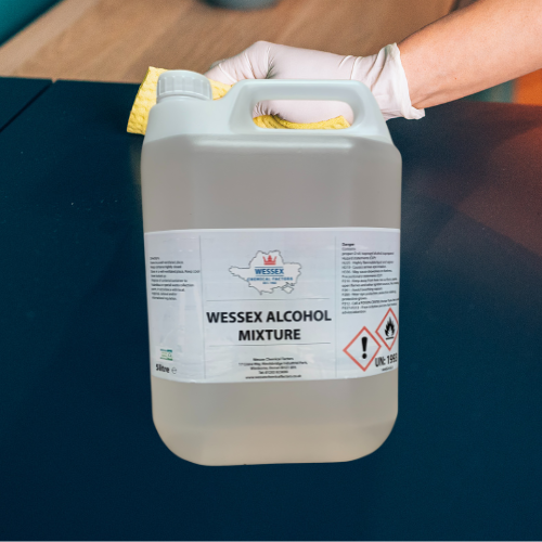 bottle of wessex alcohol mix in front of hand wiping down vinyl surface